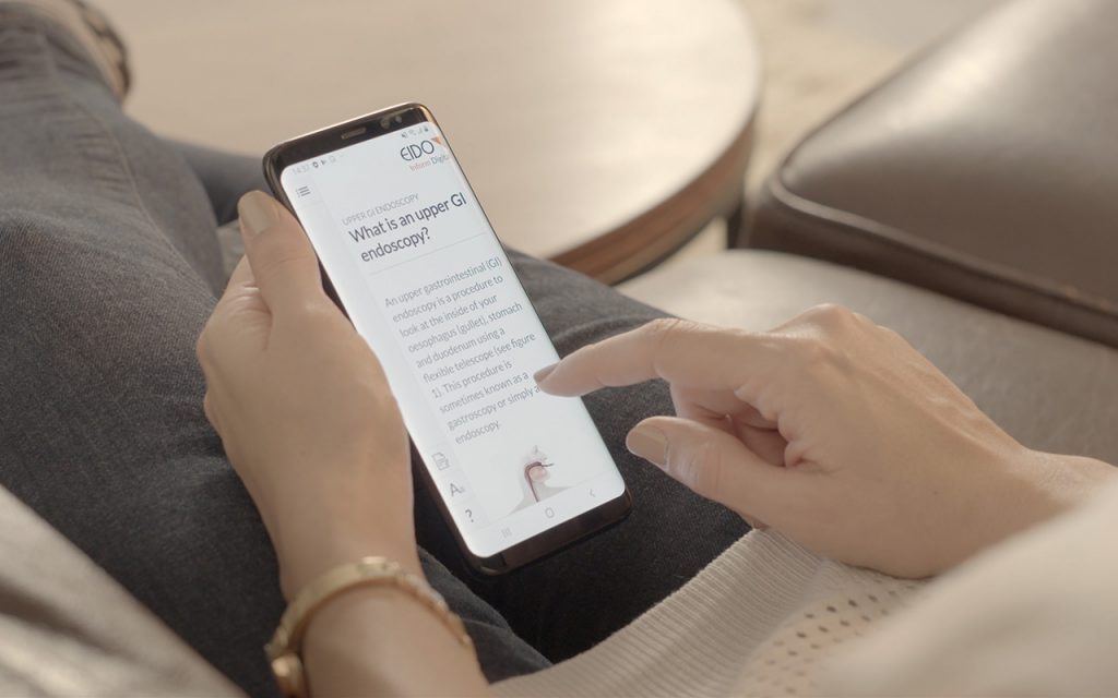 Somebody using a mobile phone that is displaying a medical document